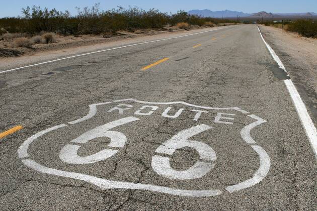 Sep 24, 2006; Goffs, CA, USA; U.S. Route 66 (also known as Route 66 or Will Rogers Highway) was a highway in the U.S. Highway system. One of the original federal routes, US 66 was established on November 11, 1926, though signs did not go up until the following year. It originally ran from Chicago, Illinois through St. Louis, Missouri, Kansas, Oklahoma, Texas, New Mexico, Arizona and California before ending at Los Angeles for a total of 2,448 miles (3,939 km). Route 66 underwent many improvements and realignments. One of those resulted in the movement of the endpoint from Los Angeles to Santa Monica. Contrary to common belief, Route 66 never ran to the ocean; it terminated onto what was then US-101, at the intersection of what is today Lincoln Boulevard and Olympic Boulevard. Route 66 was a major migratory path west, especially during the Dust Bowl of the 1930s, and supported the economi - ZUMAm69_ 20060924_mdm_m69_115