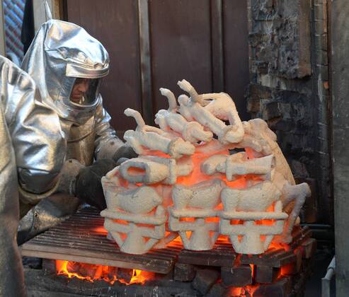 Workers in fire suits pour molten bronze metal into molds during the casting of the Screen Actors Guild Award statuettes at the American Fine Arts Foundry in Burbank, California on January 17, 2017. Winners are to be announced during a live simulcast on TNT and TBS in Los Angeles on January 29, 2017.  LAP2017011701 JIMxRUYMEN