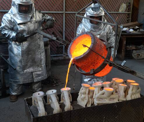 Workers in fire suits pour molten bronze metal into molds during the casting of the Screen Actors Guild Award statuettes at the American Fine Arts Foundry in Burbank, California on January 17, 2017. Winners are to be announced during a live simulcast on TNT and TBS in Los Angeles on January 29, 2017.  LAP2017011707 JIMxRUYMEN