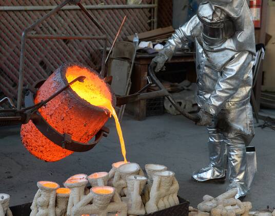 Workers in fire suits pour molten bronze metal into molds during the casting of the Screen Actors Guild Award statuettes at the American Fine Arts Foundry in Burbank, California on January 17, 2017. Winners are to be announced during a live simulcast on TNT and TBS in Los Angeles on January 29, 2017.  LAP2017011705 JIMxRUYMEN