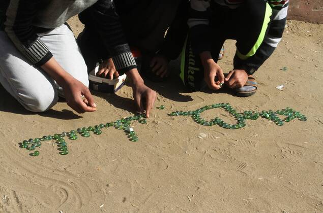 January 19, 2017 - Rafah, Gaza Strip, Palestinian Territory - Palestinian children play marbles in a street in Rafah in the southern Gaza strip on January 19, 2017 Rafah Palestinian Territory - ZUMAap3_ 20170119_zaf_ap3_035