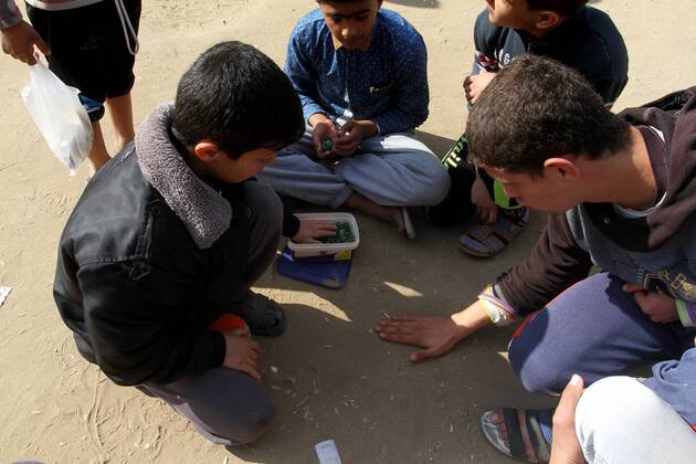 January 19, 2017 - Rafah, Gaza Strip, Palestinian Territory - Palestinian children play marbles in a street in Rafah in the southern Gaza strip on January 19, 2017 Rafah Palestinian Territory - ZUMAap3_ 20170119_zaf_ap3_037
