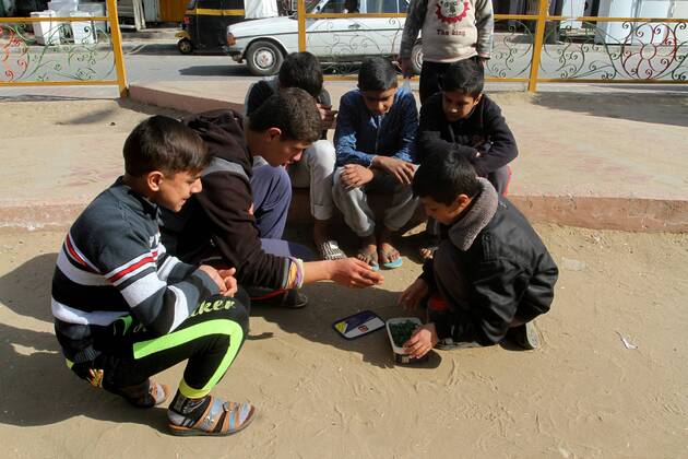 January 19, 2017 - Rafah, Gaza Strip, Palestinian Territory - Palestinian children play marbles in a street in Rafah in the southern Gaza strip on January 19, 2017 Rafah Palestinian Territory - ZUMAap3_ 20170119_zaf_ap3_040