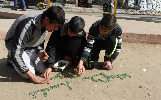 January 19, 2017 - Rafah, Gaza Strip, Palestinian Territory - Palestinian children play marbles in a street in Rafah in the southern Gaza strip on January 19, 2017 Rafah Palestinian Territory - ZUMAap3_ 20170119_zaf_ap3_041