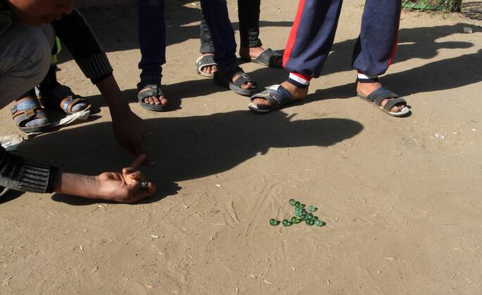 January 19, 2017 - Rafah, Gaza Strip, Palestinian Territory - Palestinian children play marbles in a street in Rafah in the southern Gaza strip on January 19, 2017 Rafah Palestinian Territory - ZUMAap3_ 20170119_zaf_ap3_042
