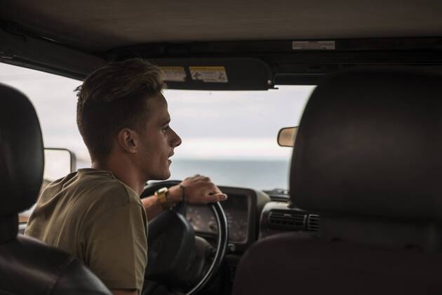 Young man driving car model released Symbolfoto SIPF01246
