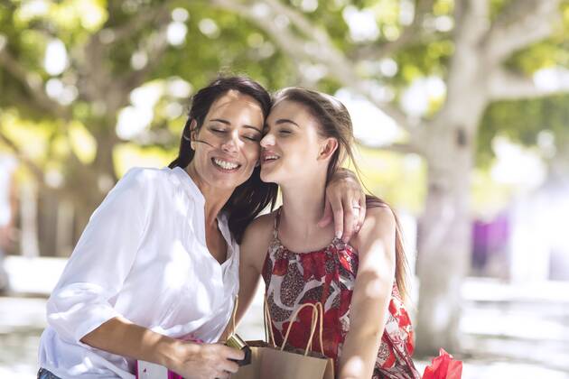 Happy mother and daughter with shopping bags embracing in the city model released Symbolfoto  ZEF13402