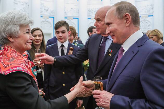 MOSCOW, RUSSIA - APRIL 28, 2017: Russia s President Vladimir Putin, chief physician of the Ochapovsky Regional Clinical Hospital No 1 (Krasnodar Territory), Vladimir Porkhanov (R-L), drink champagne after an award ceremony to present the Hero of Labour of the Russian Federation medals at Moscow s Kremlin. The Hero of Labour of the Russian Federation title is bestowed on Russian citizens for their contribution to Russia s society, economy, culture, education, industry, and agriculture. Mikhail Klimentyev Russian Presidential Press and Information Office TASS TS04A01F