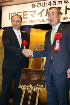 June 14, 2017, Tokyo, Japan - National Astronomical Observatory of Japan (NAOJ) Director General Masahiko Hayashi (L) shakes hands with Mistubishi Electric president Masaki Sakuyama (R) as they receive a plaque of Institute of Electrical and Electronics Engineers (IEEE) Milestone award from IEEE in Tokyo on Wednesday, June 14, 2017. NAOJ s Nobeyama 45-meters radio telescope has been recognized for an IEEE Milestone as the world s largestmillimeter-wave radio telescope to discover a supermassive black hole.  (lwxa011364)