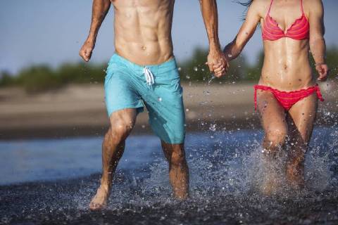 Couple holding hands splashing in water model released Symbolfoto  VPIF00005