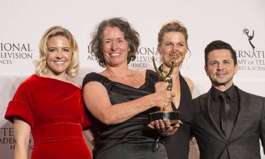 USA: 2017 International Emmy Awards Beatrice Kramm, Lucia Haslauer winner short form series & Helene Yorke, Freddy Rodriguez pose on stage at press room for 2017 Internation Emmy Awards at Hilton Hotel New York New York United States Hilton Hotel  LevxRadin
