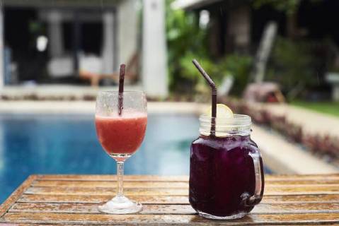 Two fruity cocktails at the poolside in rain property released  IGGF00238