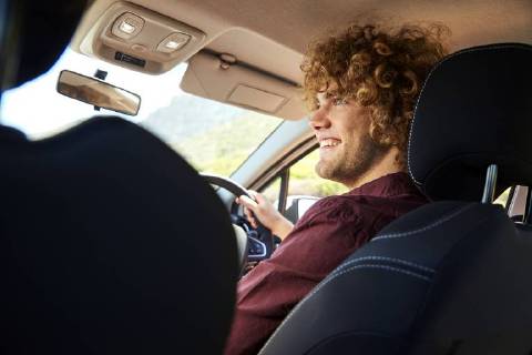 Young man driving car model released Symbolfoto SRYF00579