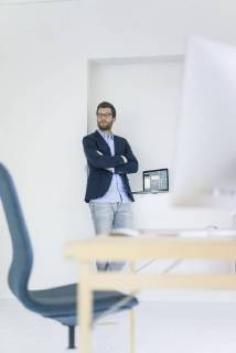 Businessman standing in office model released Symbolfoto property released  MOEF00660