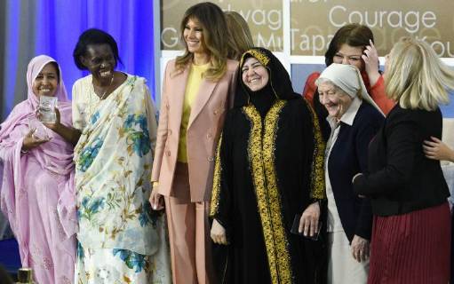 United States First Lady Melania Trump laughs as she stands for a photo with winners of the 2018 International Women of Courage Award, including L Malouma Said of Mauritania, Godelieve Mukasarasi of Rwanda, Dr. Julissa Villanueva of Honduras, Aliyah Khalaf Saleh of Iraq, Aiman Umarova of Kazakhstan, Sister Maria Elena Berini of Italy, and Dr. Fredide Rushdi of Kosovo during the Award Ceremony at the State Department in Washington, DC on March 23, 2018.  WAP20180323902 LEIGHxVOGEL