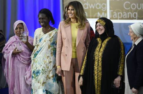 United States First Lady Melania Trump laughs as she stands for a photo with winners of the 2018 International Women of Courage Award, including L Malouma Said of Mauritania, Godelieve Mukasarasi of Rwanda, Dr. Julissa Villanueva of Honduras, Aliyah Khalaf Saleh of Iraq, Aiman Umarova of Kazakhstan, and Sister Maria Elena Berini of Italy during the Award Ceremony at the State Department in Washington, DC on March 23, 2018.  WAP20180323907