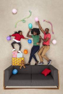 Little daughter celebrating birthday party, dancing with her parents model released Symbolfoto  BAEF01582