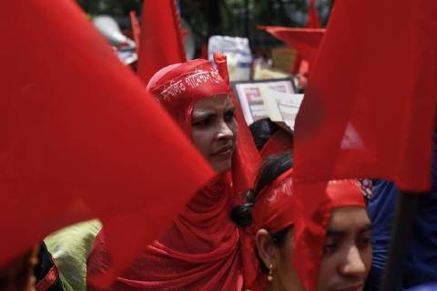 April 30, 2018 - Dhaka, Bangladesh - A garment worker looks on as she attends a procession to mark May Day or International Workers Day in Dhaka. Dhaka Bangladesh - ZUMAh143 20180430_zap_h143_014 Copyright: xMDxMehedixHasanx