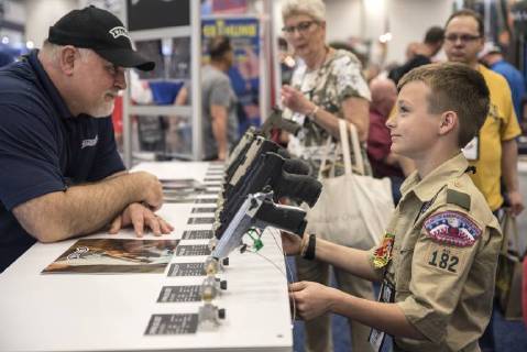 Themen der Woche KW 18 Bilder des Tages A convention attendee inspect a gun on the floor of the exhibition hall at the 147th National Rifle Association (NRA) Annual Meetings and Exhibits at the Kay Bailey Hutchison Convention Center in Dallas on May 5, 2018.  DAL20180505325 SERGIOxFLORES