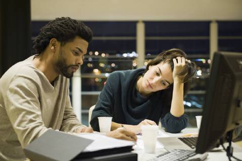 Colleagues working on project together in office at night  Copyright: EricxAudras B66003718