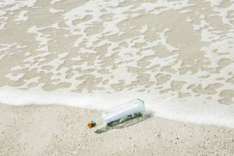 Message in a bottle washed up on shore  Copyright: MichèlexConstantini B50797509