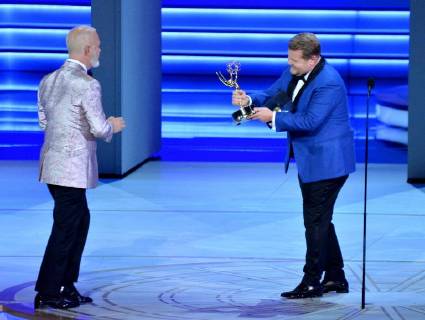Ryan Murphy (L) accepts the Outstanding Directing for a Limited Series, Movie, or Dramatic Special award for The Assassination of Gianni Versace: American Crime Story from James Corden onstage during the 70th annual Primetime Emmy Awards at the Microsoft Theater in downtown Los Angeles on September 17, 2018.  LAP201809171118 JIMxRUYMEN