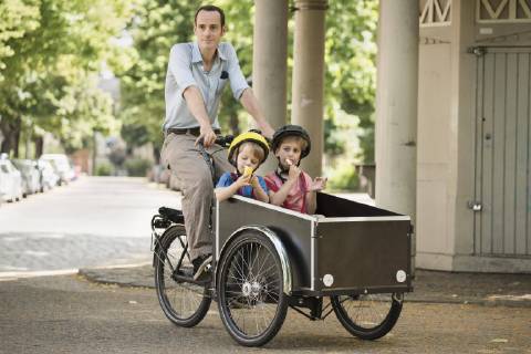 Father with boys riding bicycle with cart on street  Copyright: Halfdark fStopImages1547001
