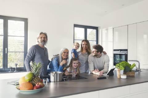 Happy family with grandparents and children standing in the kitchen model released Symbolfoto property released SBOF00512