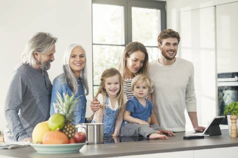 Happy family with grandparents and children standing in the kitchen model released Symbolfoto property released SBOF00510