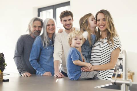 Happy family with grandparents and children standing in the kitchen model released Symbolfoto property released SBOF00516