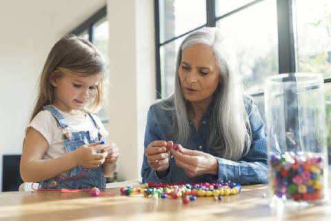 Grandmother and granddaughter threading beads model released Symbolfoto property released  SBOF00574