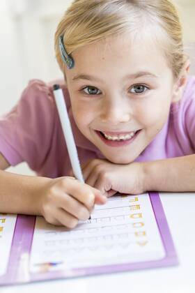 Portrait of smiling little girl writing alphabet model released Symbolfoto  JFEF00891