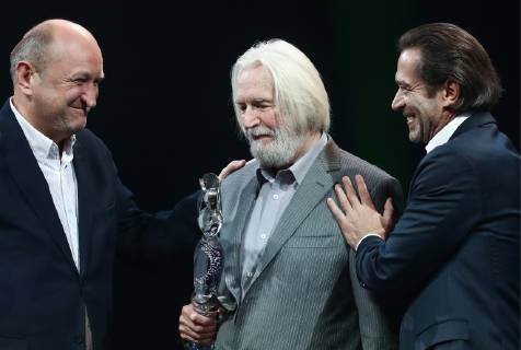 MOSCOW, RUSSIA - OCTOBER 22, 2018: Sergei Zhenovach, Artistic Director of the Chekhov Moscow Art Theatre (L) and Vladimir Mashkov (R), Head of the Oleg Tabakov Studio Theatre, congratulate actor Stanislav Lyubshin on winning the Honour and Dignity prize at a ceremony for the 27th Crystal Turandot Award, an independent theatre prize, held at Moscow s Vakhtangov Theatre. Valery Sharifulin TASS  TS094CA2