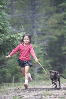 a girl runs with her puppy in the wilderness., Nederland Colorado USA model released Symbolfoto Copyright: TopherxDonahue DOTO000013