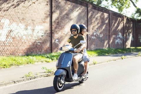 Couple riding motor scooter in summer model released Symbolfoto  JOSF02604