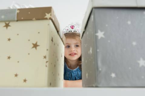 Girl with tiara in front of gift boxes  Copyright: OdilonxDimier B43540328