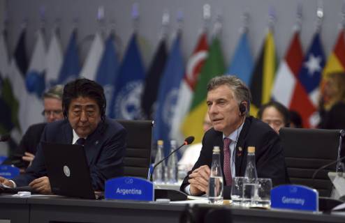 December 1, 2018 - Buenos Aires, Argentina - Argentine President Mauricio Macri, right, address the plenary session on Day Two of the G20 Summit meeting as Japanese Prime Minister Shinzo Abe, left, looks on at the Costa Salguero Center December 1, 2018 in Buenos Aires, Argentina. Buenos Aires Argentina - ZUMAp138 20181201_zaa_p138_046 Copyright: xG20xArgentinax