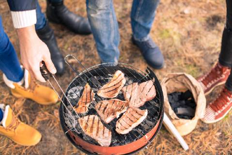  People cooking meat on charcoal grill  Copyright: xLightFieldStudiosx Panthermedia20174879