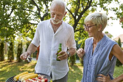 Senior couple having a barbecue in garden model released Symbolfoto property released  ZEDF01597