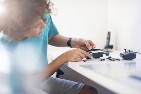 Boy repairing drone model released Symbolfoto  DIGF05128