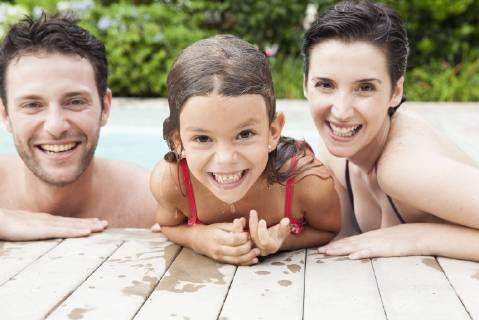 Family relaxing together in pool, portrait  Copyright: SigridxOlsson B35778922