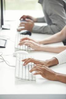 Office workers using computer keyboards  Copyright: OdilonxDimier B58977227