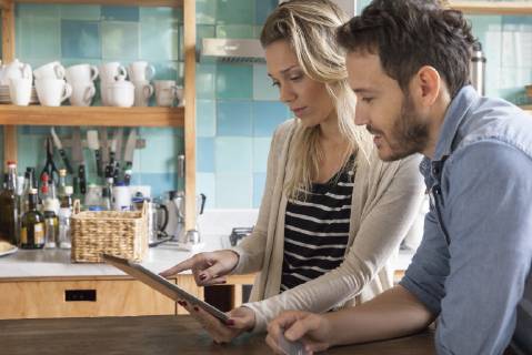 Couple using digital tablet to shop online Copyright: SigridxOlsson B60890021
