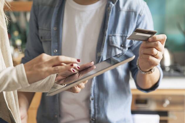 Couple using digital tablet to shop online Copyright: SigridxOlsson B60992821