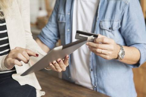 Couple using digital tablet to shop online Copyright: SigridxOlsson B62193521
