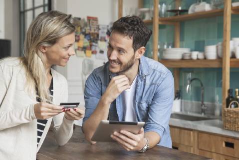 Couple using digital tablet to shop online at home Copyright: SigridxOlsson B69296221