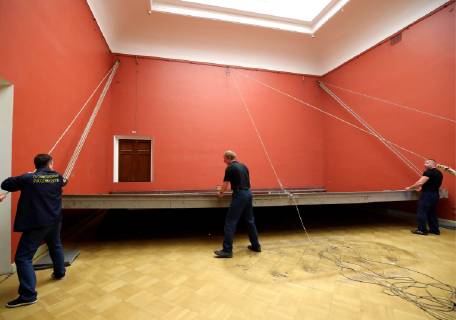 ST PETERSBURG, RUSSIA - FEBRUARY 11, 2019: Russian Museum workers take a painting by Ilya Repin, Ceremonial meeting of the State Council of 7 May 1901 on the day of the Centenary of its Establishment , off its stretcher in Mikhailovsky Castle (St Michael s Castle) as it is prepared to be shipped to Moscow for a Tretyakov Gallery exhibition marking Ilya Repin s 175th birthday anniversary. Peter Kovalev TASS  TS0A0930