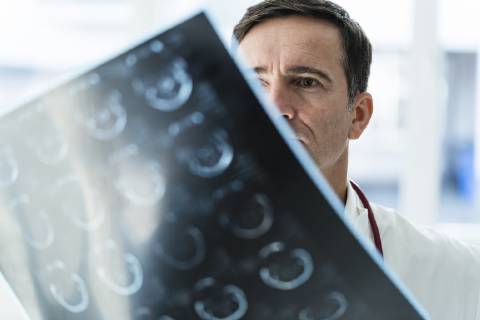 Doctor examining MRT image in medical practice model released Symbolfoto property released  JOSF02805