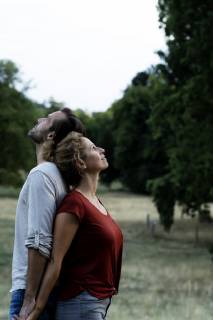 Happy couple standing in nature, back to back model released Symbolfoto  HHLMF00588
