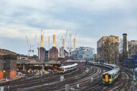 United Kingdom, England, London, view of railtracks and trains in the evening, former Battersea Power Station and cranes in the background WPEF01262
